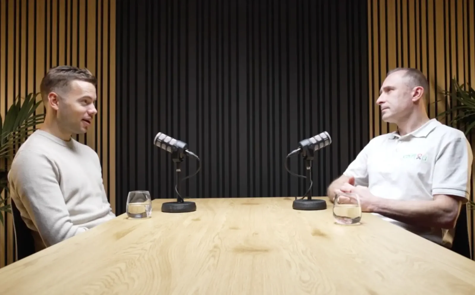 Martin Brath interviewing a guest in a podcast studio